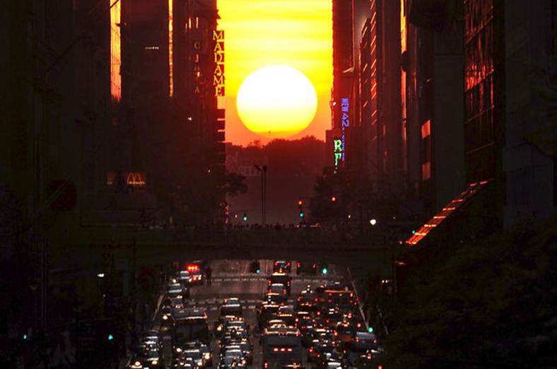 Description: Description: Description: The sun shines down 42nd Street in New York City at sunset during "Manhattanhenge," May 30, 2011. Photographer: Xinhua News Agency/eyevine/Redux